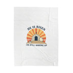 White towel with 'He is Risen, I'm Still Waking Up' graphic design on a white background
