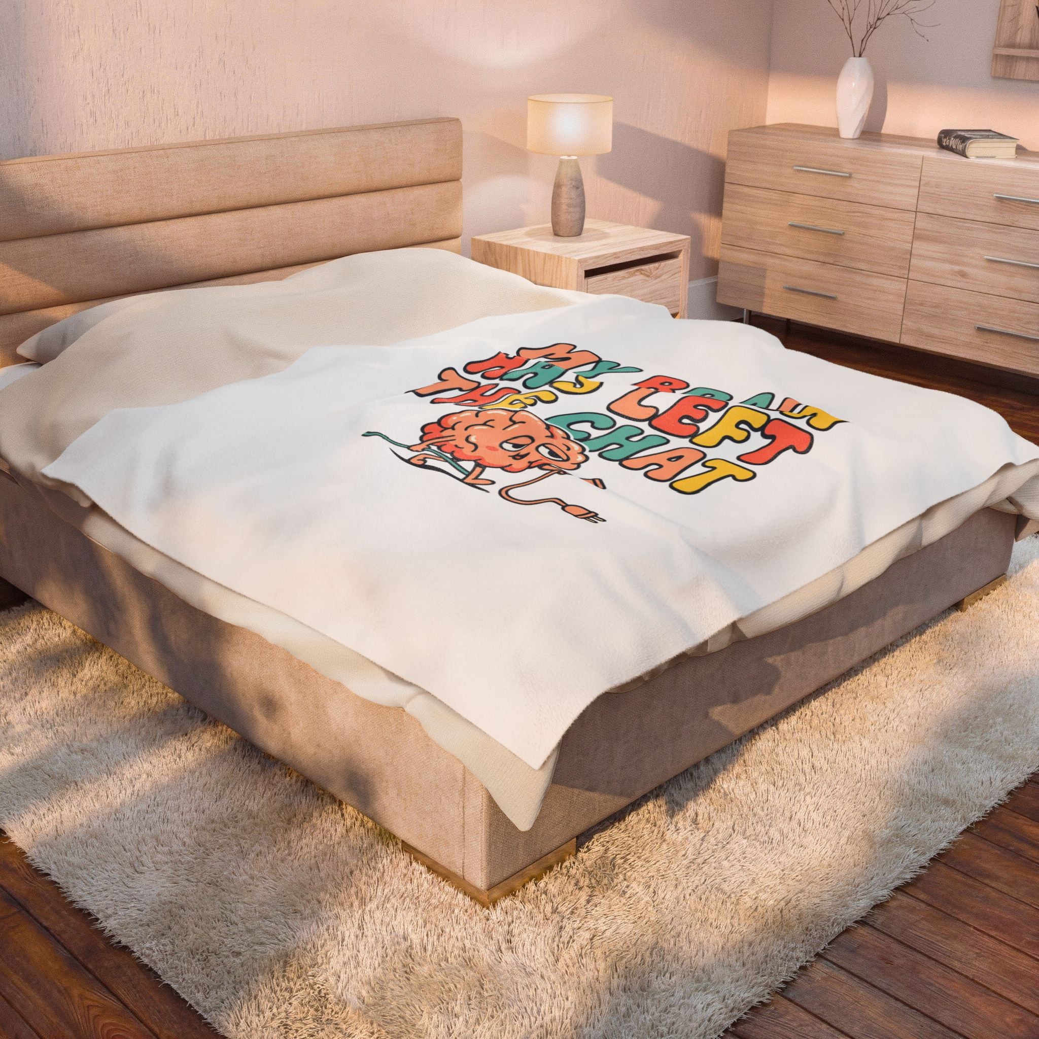 Bed with a colorful graphic blanket in a bedroom setting