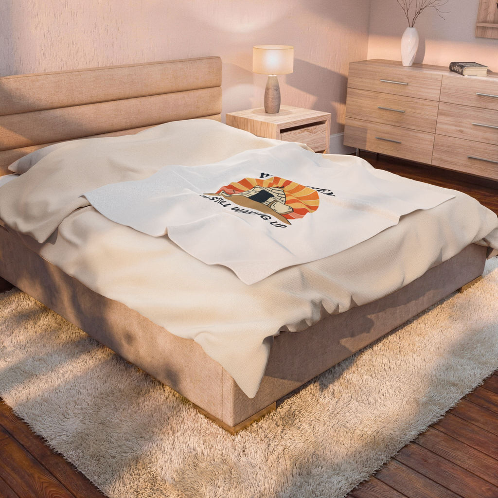 Beige bedspread with a logo on a bed in a bedroom setting
