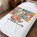 Blanket with a colorful graphic of a brain and text on a bed in a bedroom.