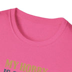 Close-up of a pink shirt with text in green on a white background